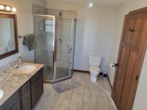 Photo of a spacious bathroom with walk in shower at the hunting lodge at Prairie Legends Outfitters in Winner, South Dakota.