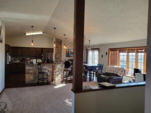 Interior view of the living room, dining room and kitchen area in the hunting lodge.